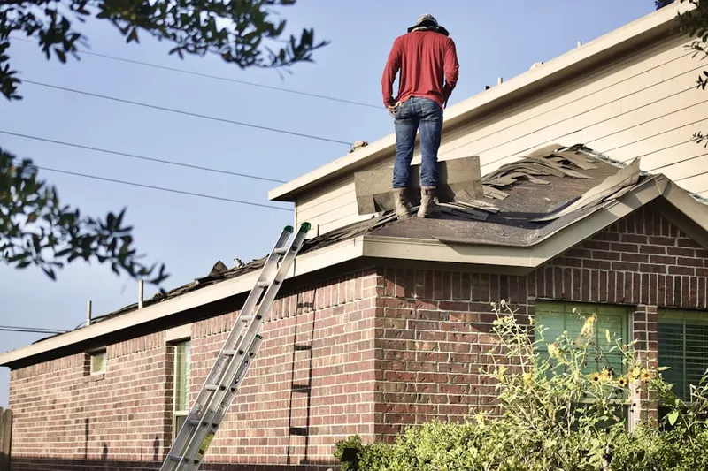 Professional roofer working on a residential roof in Cardington